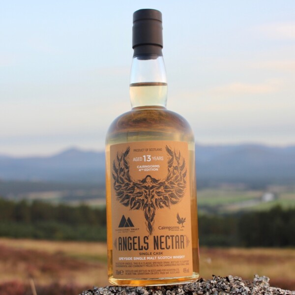 Bottle of Angels' Nectar Cairngorms 4th Edition with strathspey and cairngorm mountains in background